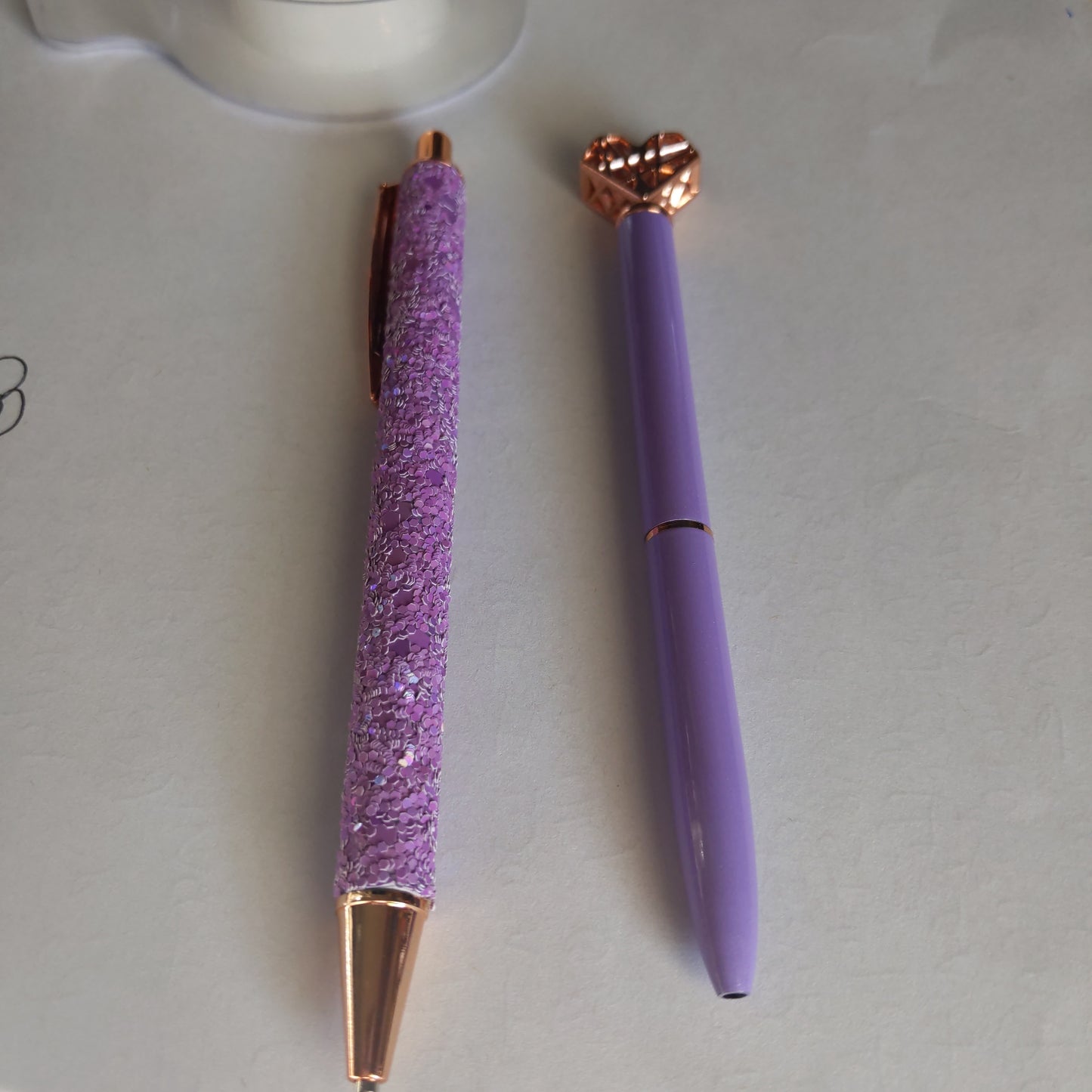 Two Writing Purple Pens
